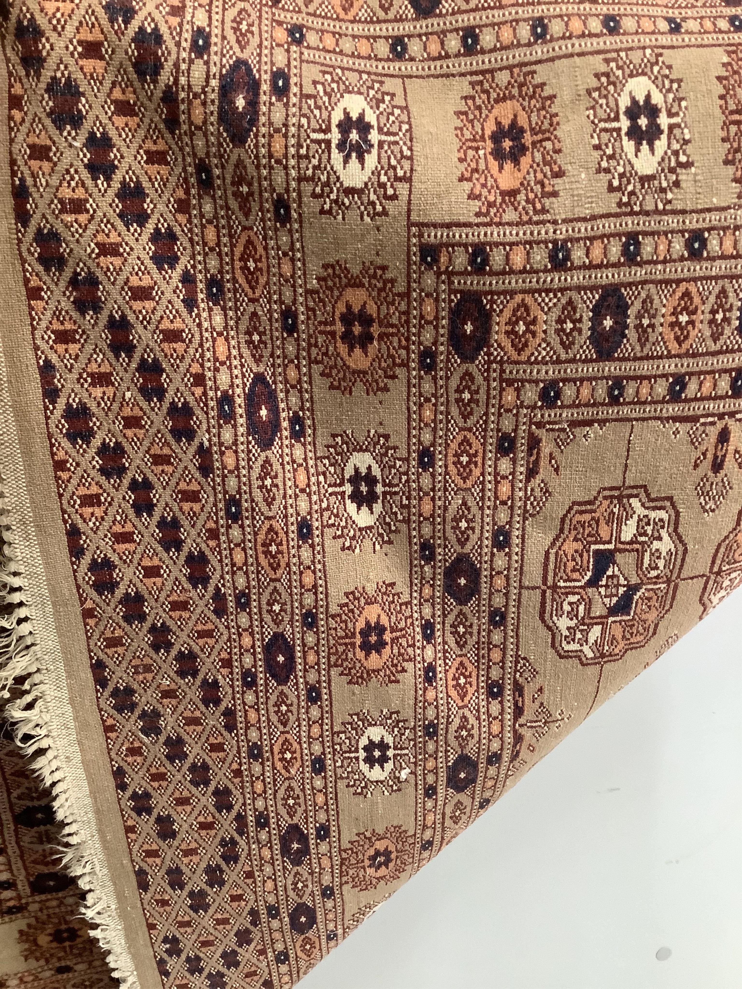 A Bokhara fawn ground rug, 190 x 120cm. Condition - fair